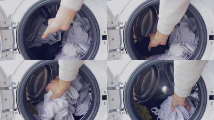 手从洗衣机中取出衣物