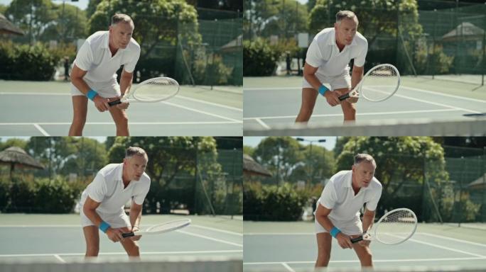 健康的人站在网球场上准备击球