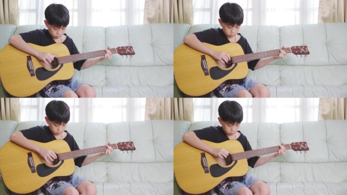 玩原声吉他的亚洲男孩