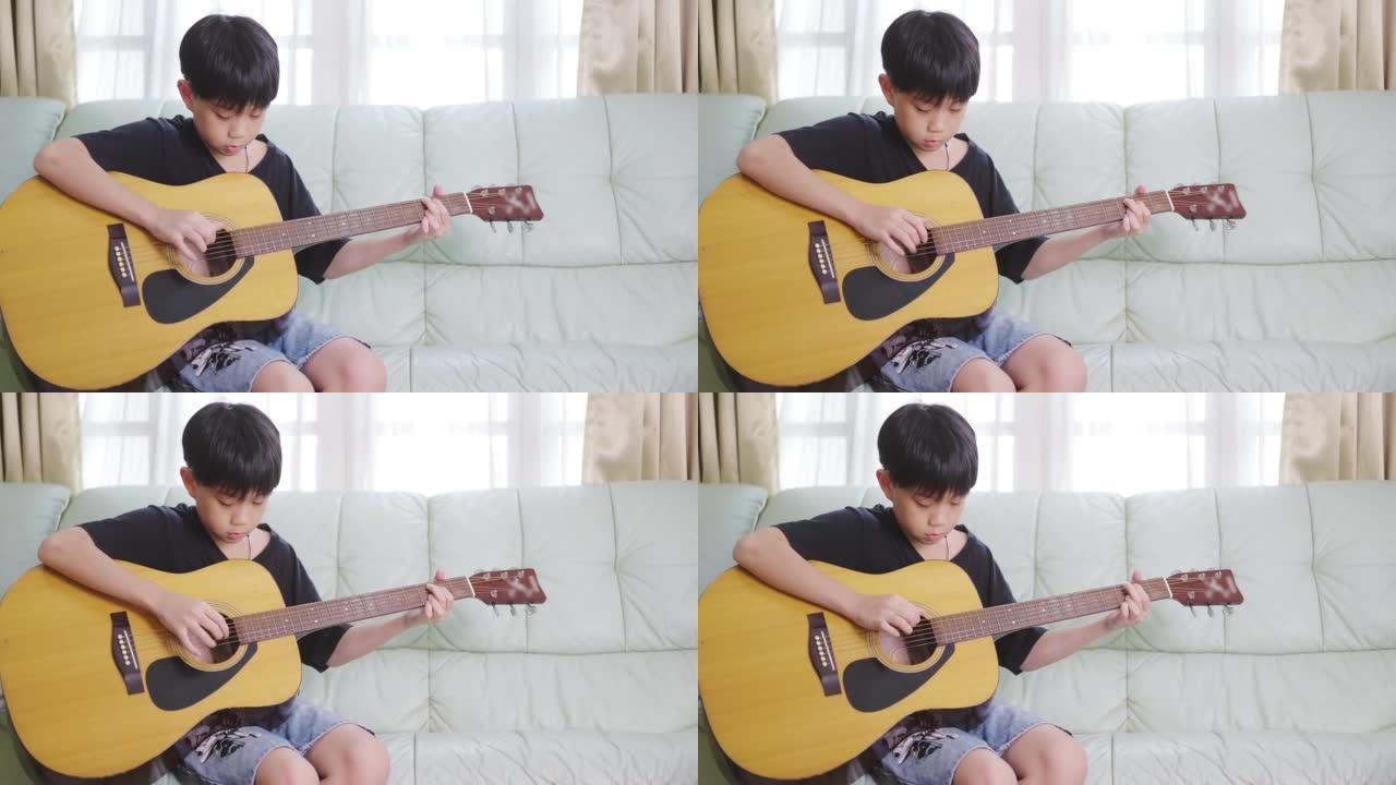 玩原声吉他的亚洲男孩