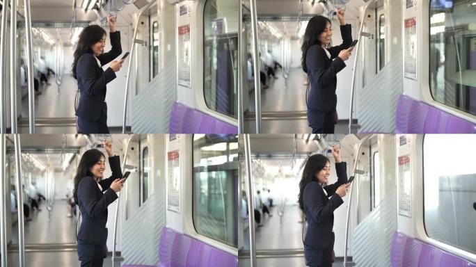 在火车上使用智能手机的女商人