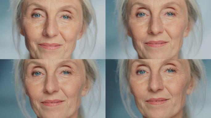 美丽的高级女人转身的特写肖像，看着相机，笑容灿烂。华丽的外貌年迈的祖母，有着自然的灰色头发、蓝色的眼