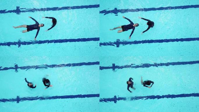 游泳池教练教练正上方的无人机观点教他的高年级学生游泳技能