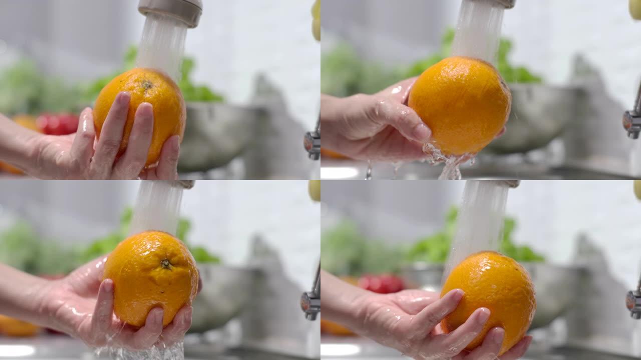 手洗橙色水果，慢动作