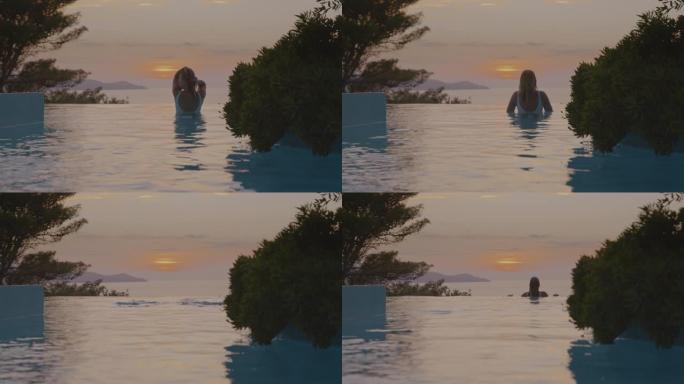 日落时在无边泳池中享受游泳的女人的SLO MO肖像