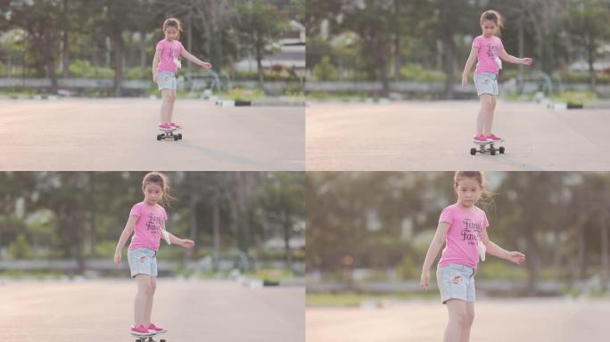玩滑板的亚洲女孩滑板少年小女孩练习滑板周