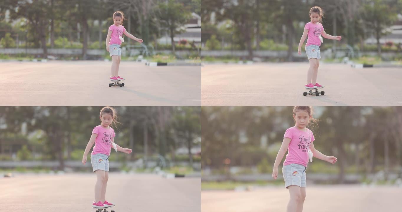 玩滑板的亚洲女孩滑板少年小女孩练习滑板周