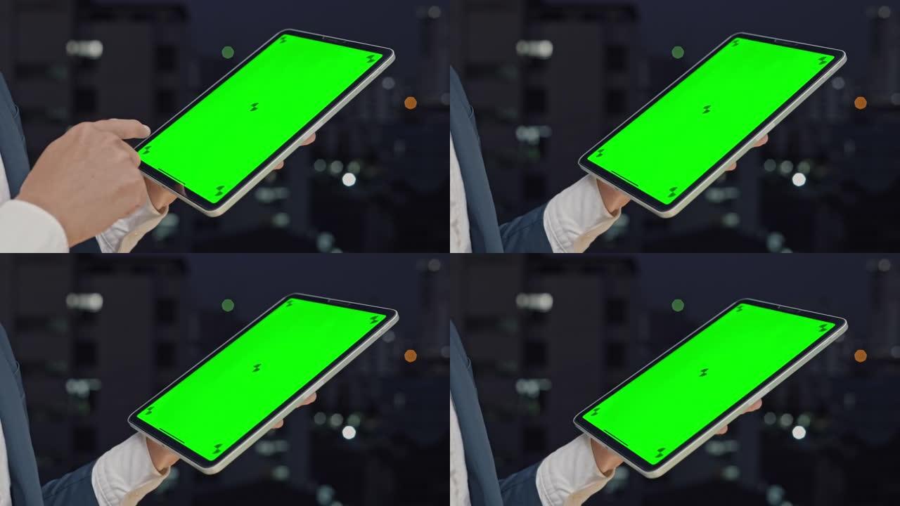 商人使用色度键绿屏平板电脑，特写