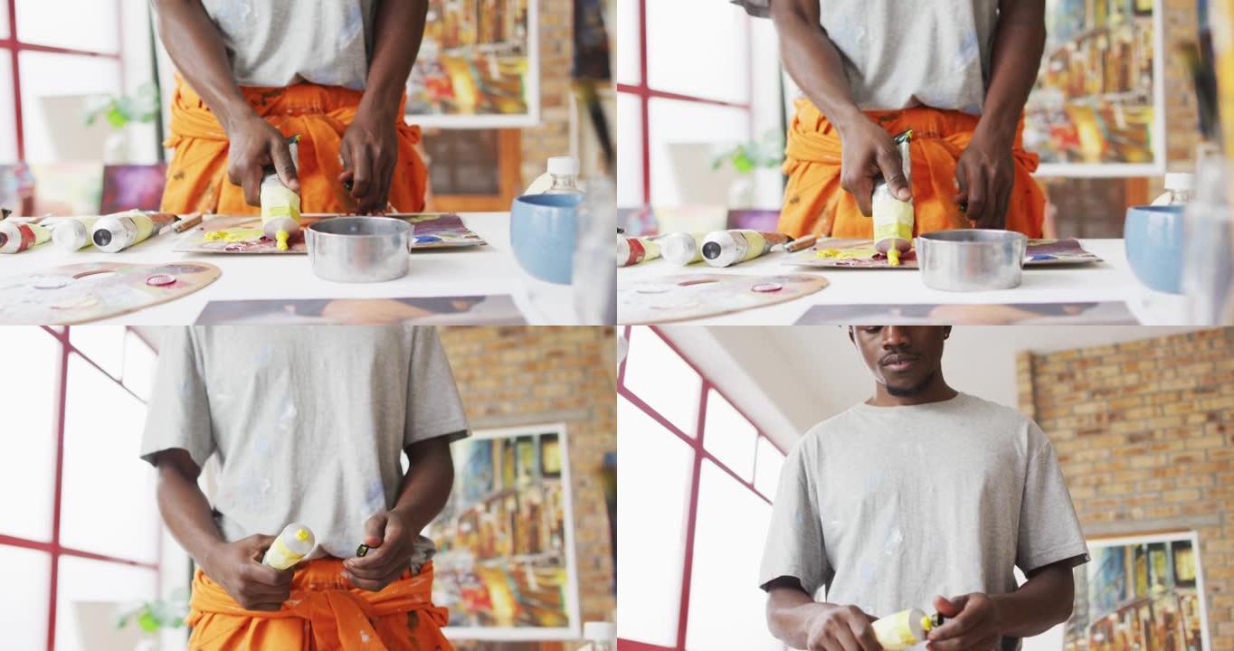 非裔美国男性画家在艺术家工作室混合油漆的中段