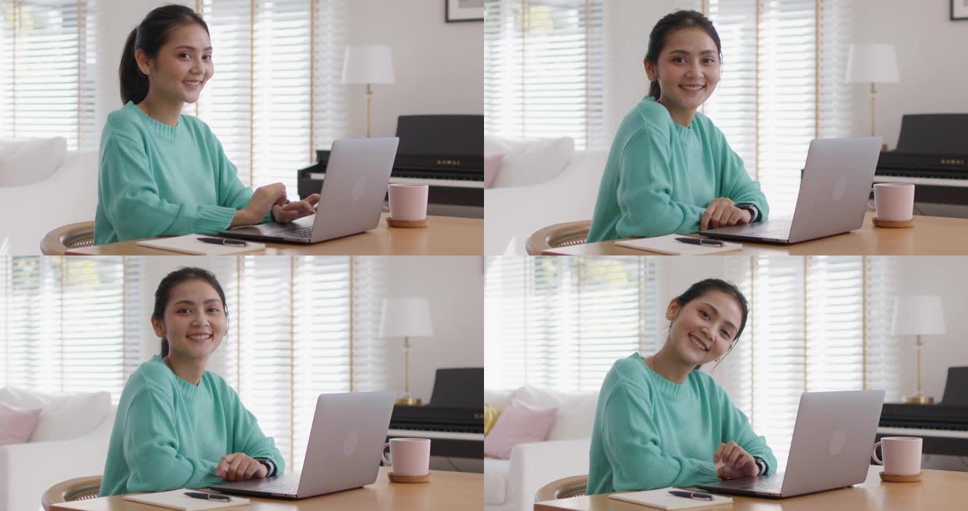 女MBA学生微笑以积极的情绪放松在家学习。