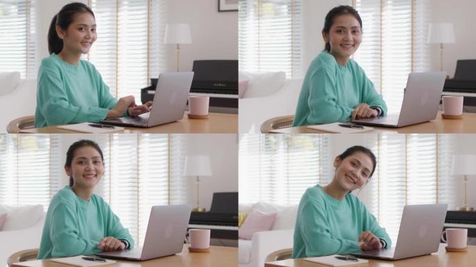 女MBA学生微笑以积极的情绪放松在家学习。