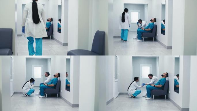 疲惫的医生在诊所走廊见面并互相支持