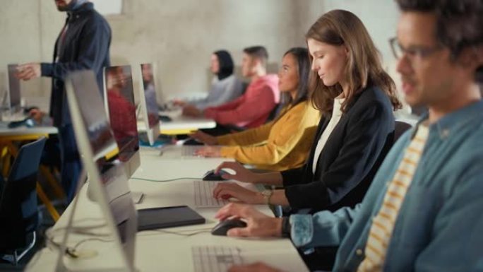 多种族的男女学生坐在大学教室里，学习计算机科学。年轻学者在大学学习计算机上的信息技术，在课堂上编写代