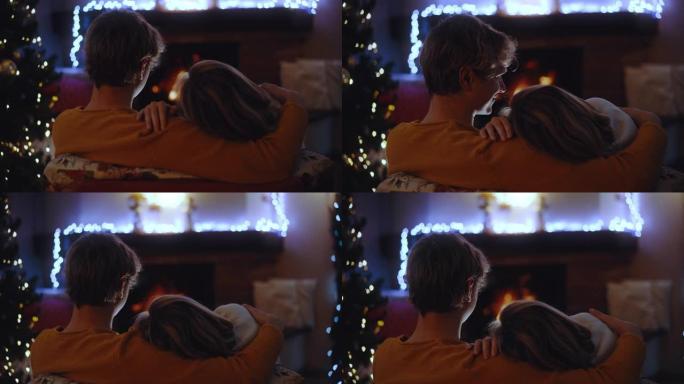 SLO MO DS年轻的情侣在壁炉前度过了一个浪漫的圣诞节假期
