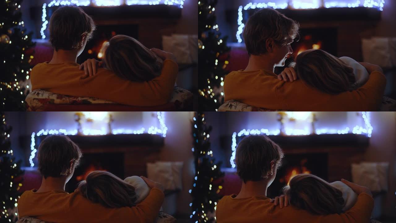 SLO MO DS年轻的情侣在壁炉前度过了一个浪漫的圣诞节假期