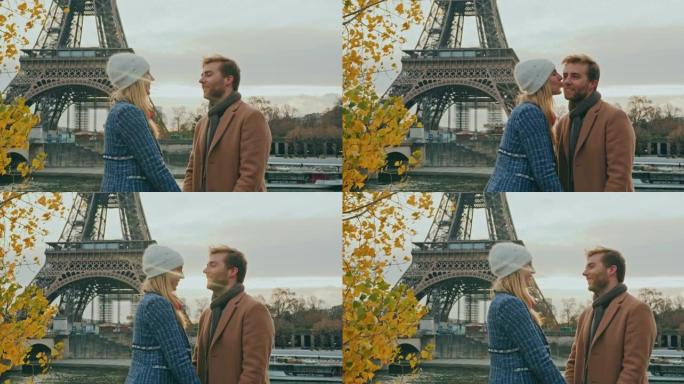 SLO MO年轻女子在埃菲尔铁塔旁的脸颊上亲吻男友
