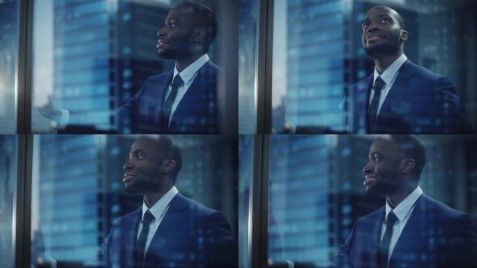 体贴的非洲裔美国商人穿着一件完美的西装，站在他的办公室里，看着窗外的大城市。成功的投资经理规划策略。