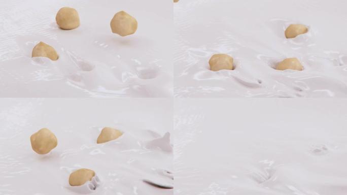榛子在4k超慢动作中溅入液体奶油中
