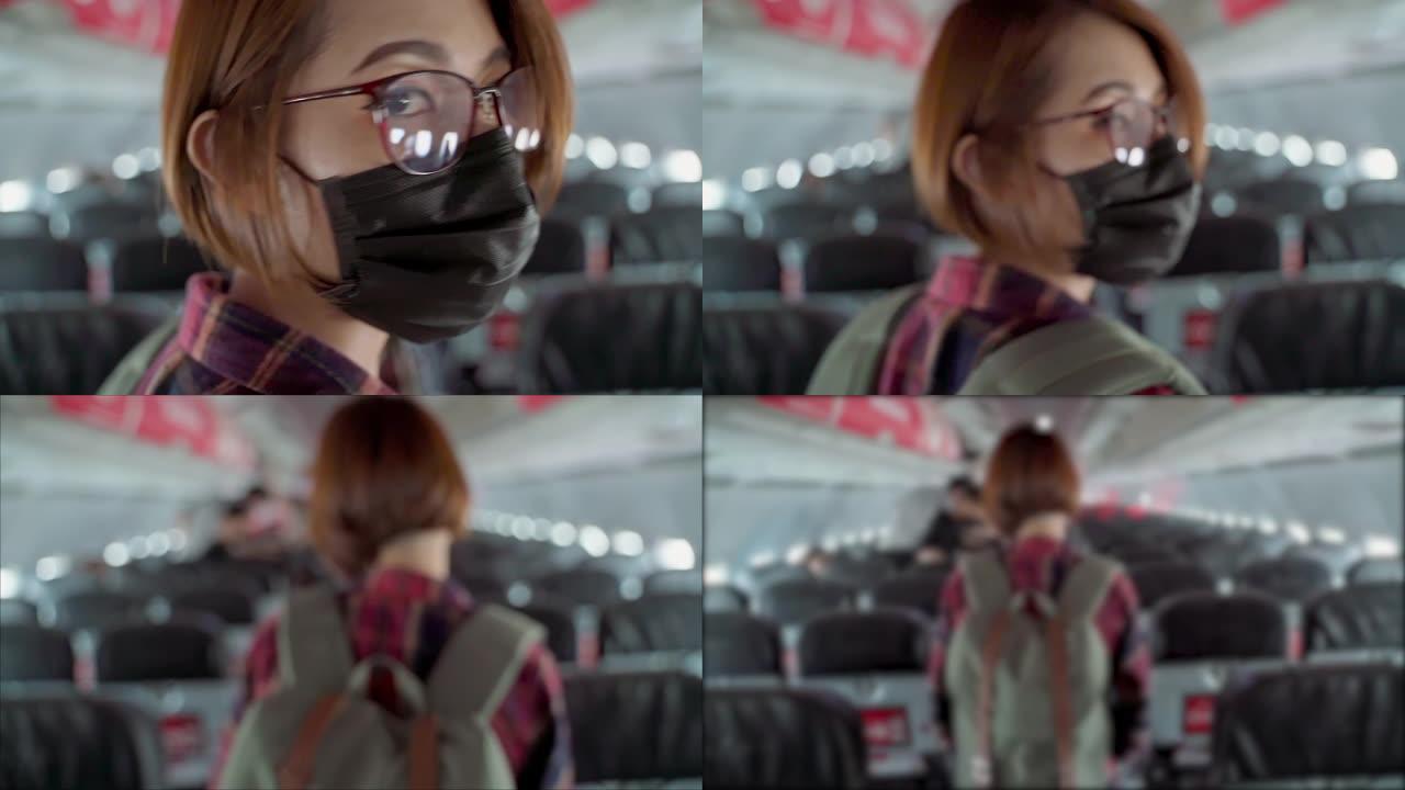 后视图亚洲女性游客在飞机上新型冠状病毒肺炎时戴着防护面罩