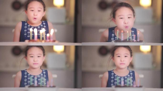 小女孩在家吹蜡烛生日蛋糕