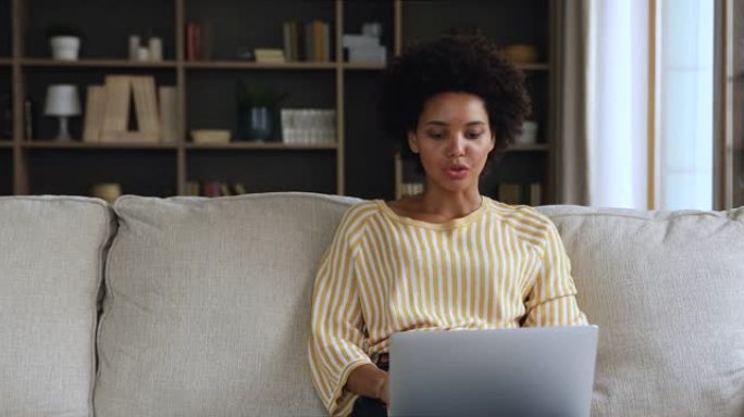 年轻的黑人女性购物者使用笔记本电脑在网上购买商品