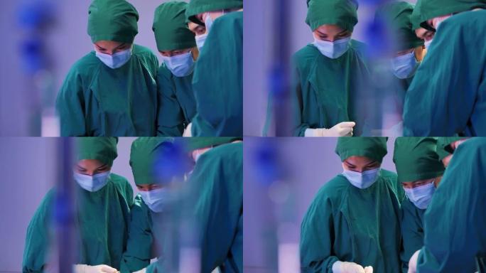 亚洲女性医生外科专业人员的特写镜头，医生团队穿着手术服，而头脑风暴力量在医院协助手术。医疗团队进行外