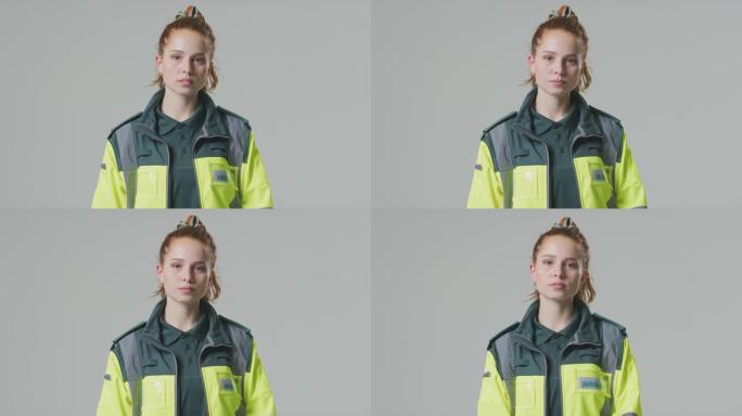 严肃的年轻女性护理人员在朴素背景下的工作室肖像