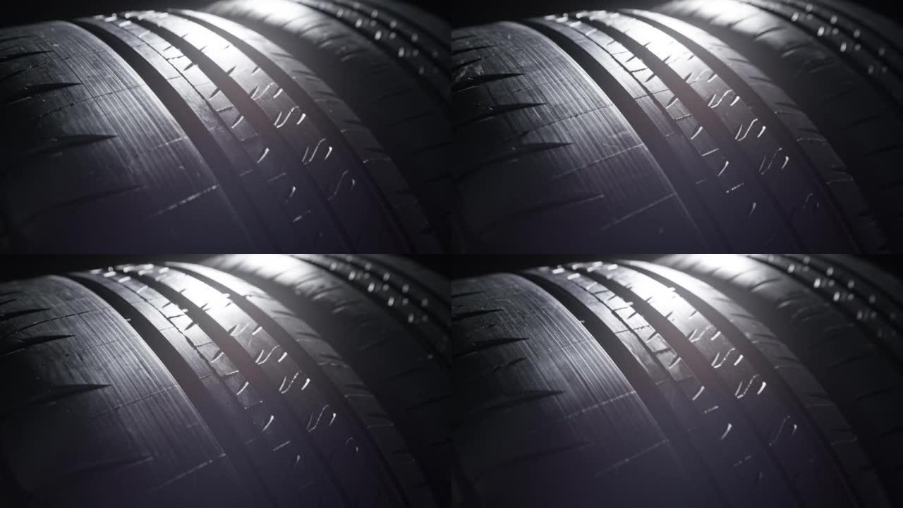 黑色背景下新夏季轮胎胎面表面的特写