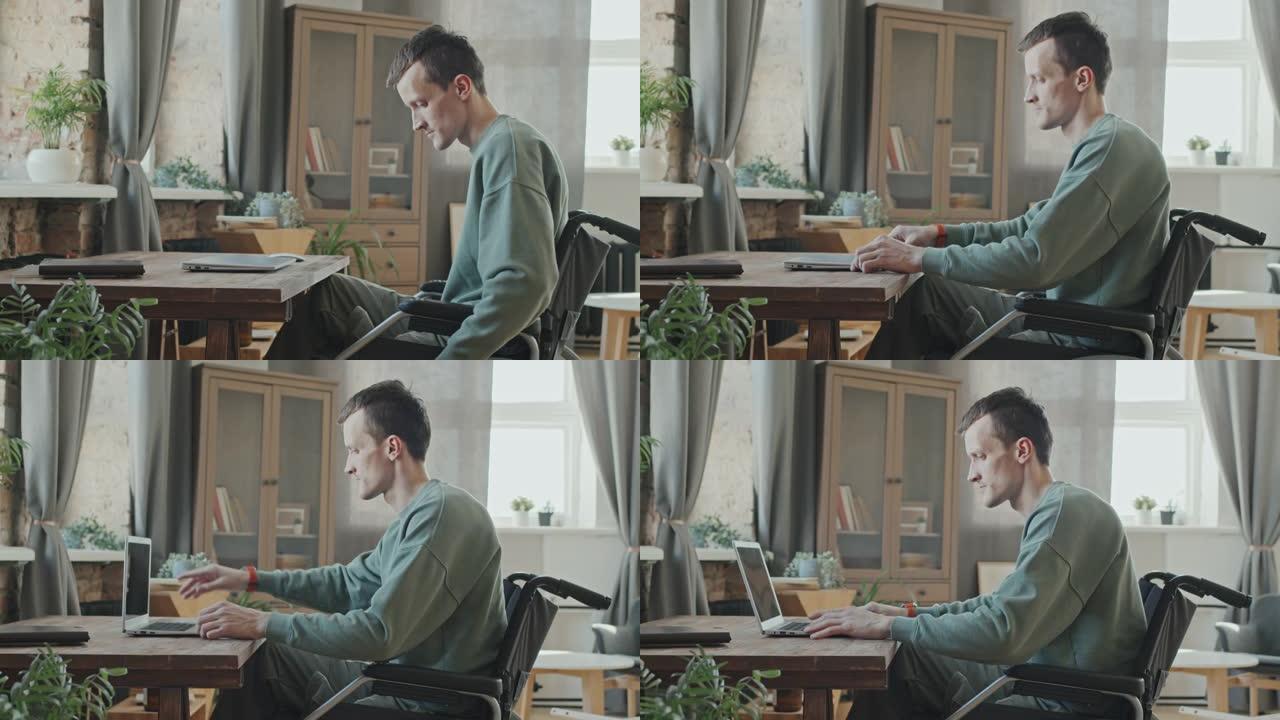 坐在轮椅上的人在笔记本电脑上工作