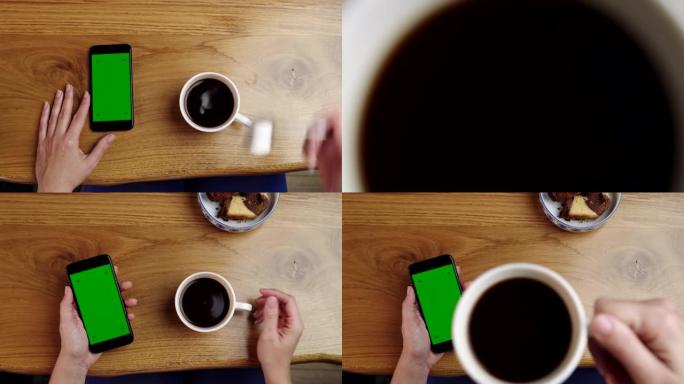 女士POV无法辨认的女人在使用带有色度键绿屏的智能手机时喝咖啡
