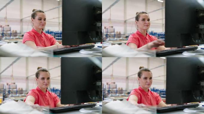 在工厂仓库用电脑工作的快乐年轻女工