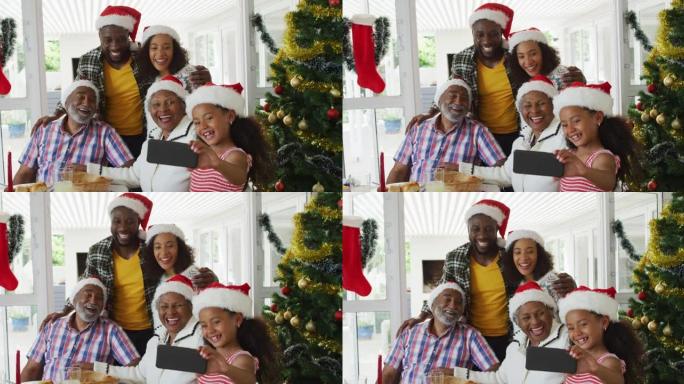 快乐的非洲裔美国多代家庭戴着圣诞老人的帽子，拍照
