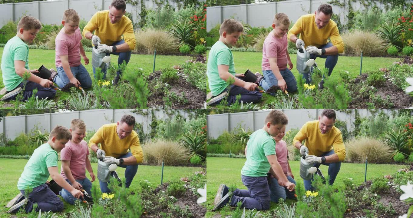 快乐的高加索父亲与两个儿子一起园艺并在花园里浇水