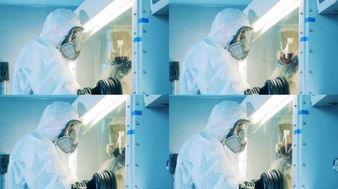 实验室工作人员正在实验室柜中观察液体样品