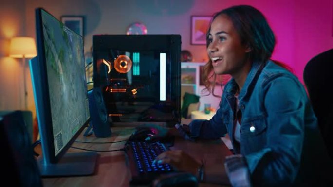 专业美丽的女性电子竞技游戏玩家在她强大的个人电脑上玩RPG MOBA模拟视频游戏现代图形和有趣的游戏