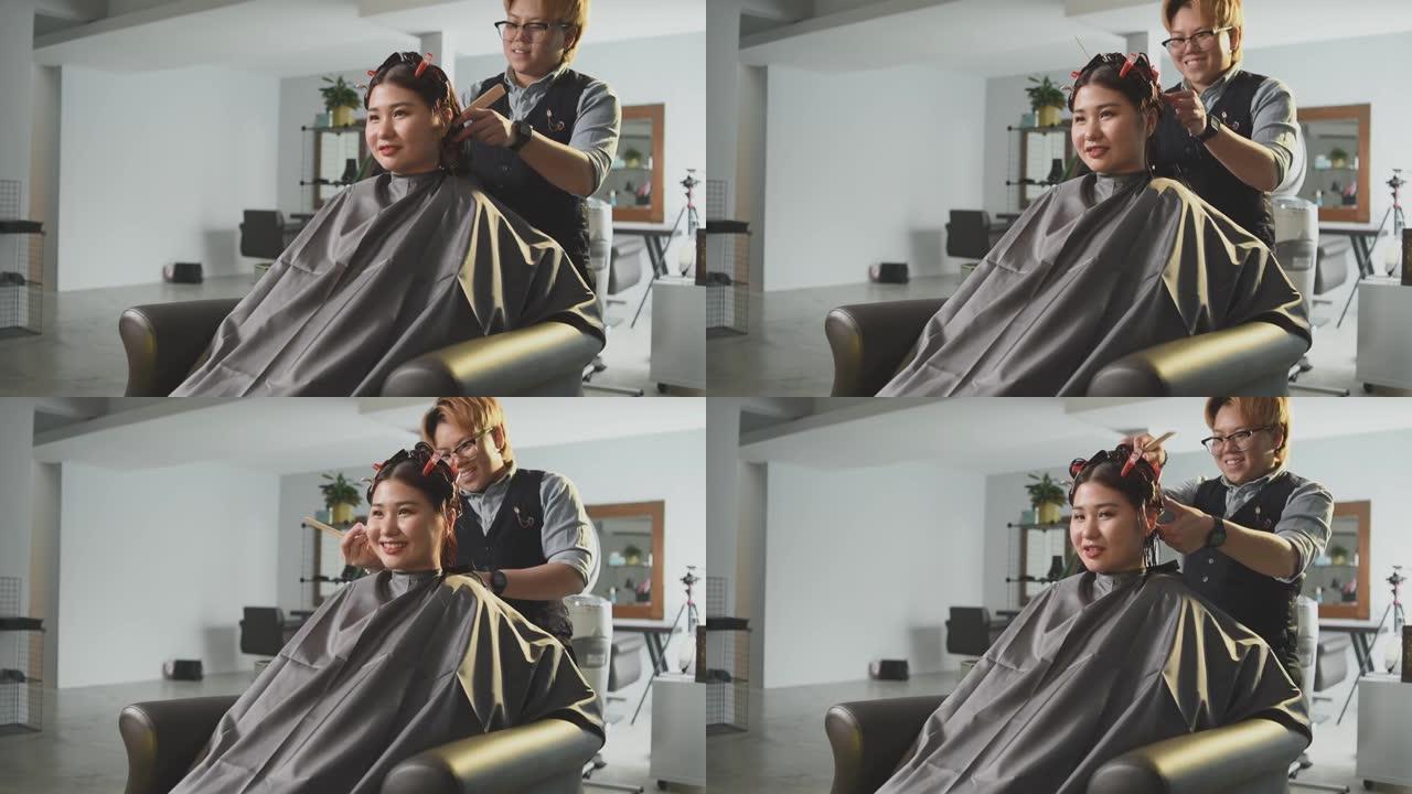 慢动作发廊亚洲中国女性发型师在发廊为她的顾客理发梳理湿长发