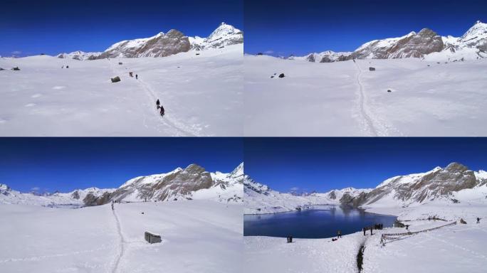 尼泊尔山区高山湖泊景观的无人机镜头。蒂利乔湖在明亮的阳光下抵御白雪覆盖的山脉