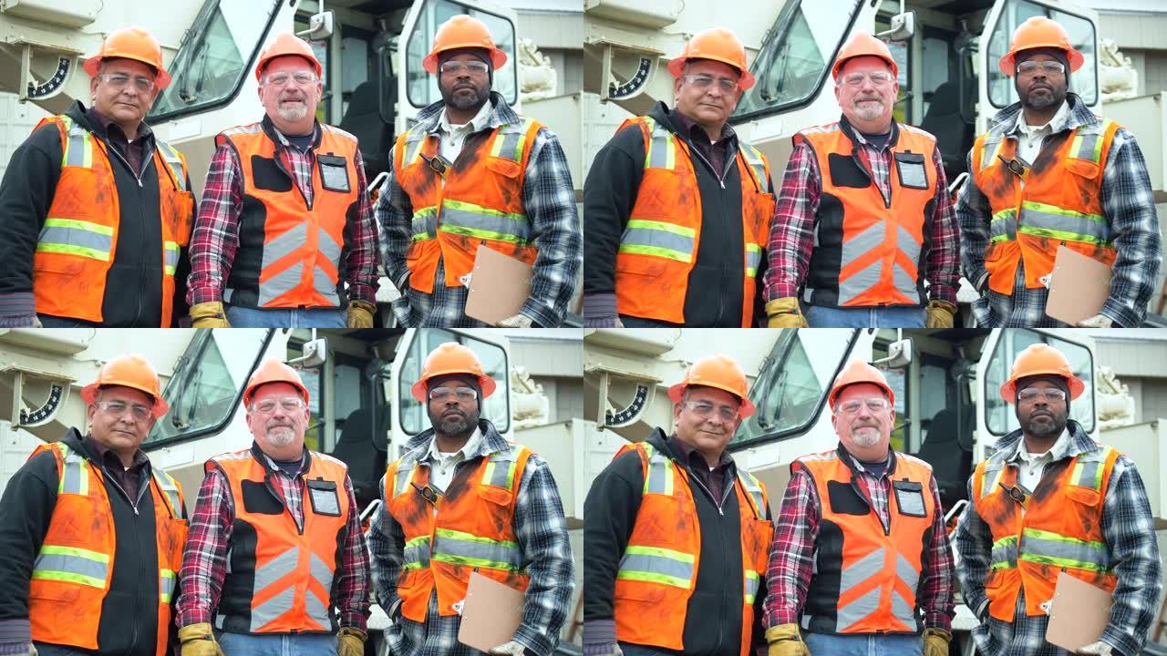 三名多种族建筑工人看着相机