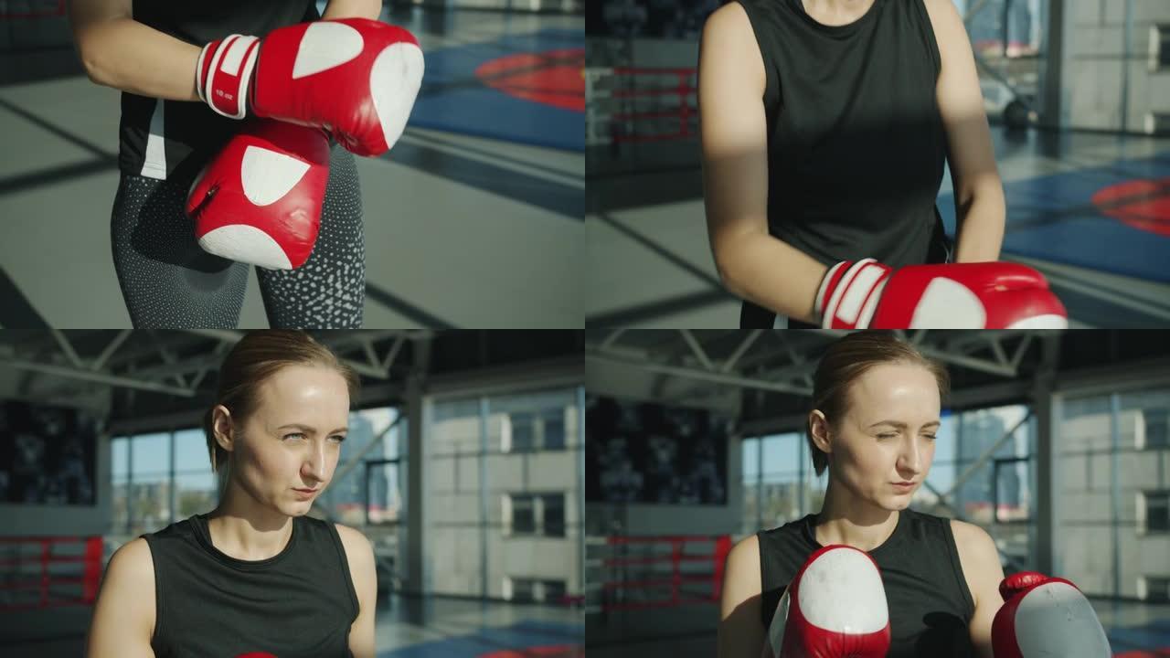 年轻的女战士戴上拳击手套准备在健身房进行个人训练