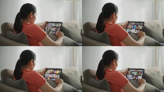 女人在平板电脑上浏览电视电影