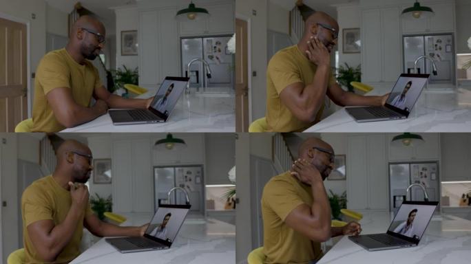 在家中的非裔美国成年男子在使用笔记本电脑进行远程医疗预约时向医生描述了自己的痛苦