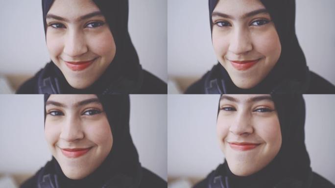 年轻的穆斯林妇女在头巾中的笑脸