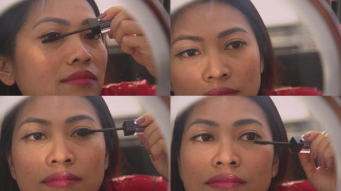 特写: 漂亮的菲律宾女人在睫毛上涂上睫毛膏的详细视图