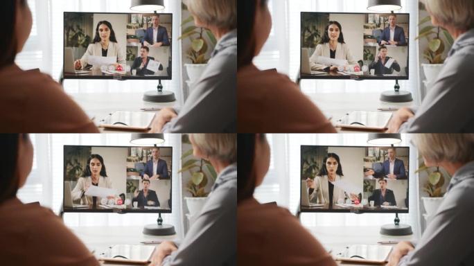 会议室电视屏幕上的在线会议视频通话中的员工多样化