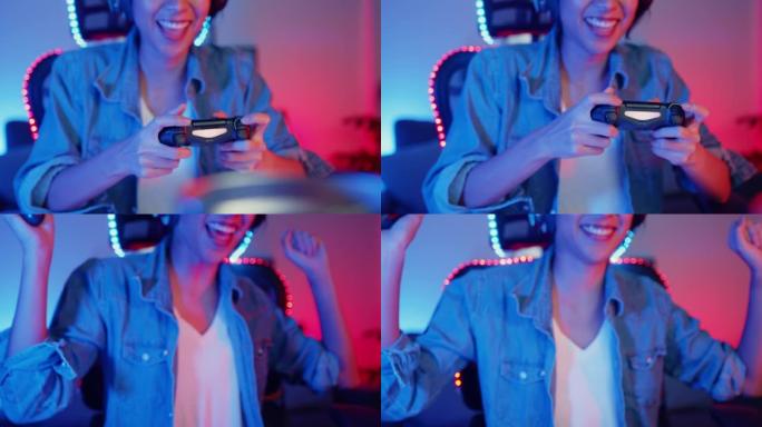 快乐的亚洲女孩游戏玩家戴着耳机和操纵杆控制器与朋友交谈，晚上在霓虹灯客厅家庭工作室的在线游戏中感到有