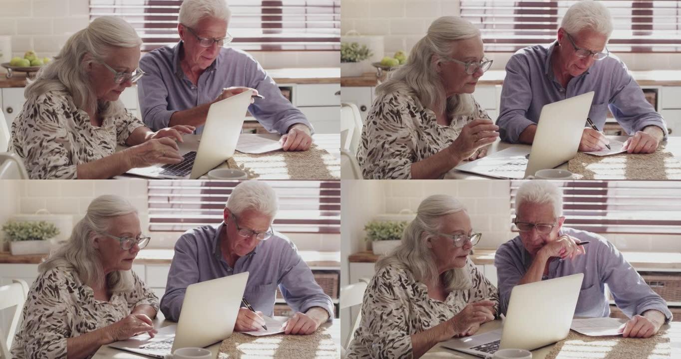 4k视频片段，一对老年夫妇坐在家里的厨房里，使用技术计算他们的财务状况