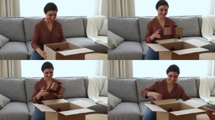 快乐的印度女人打开带礼物的包装箱