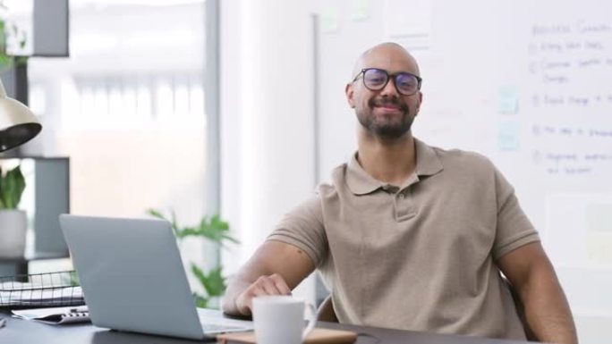一个英俊的年轻商人独自坐在办公室里使用笔记本电脑的4k视频片段