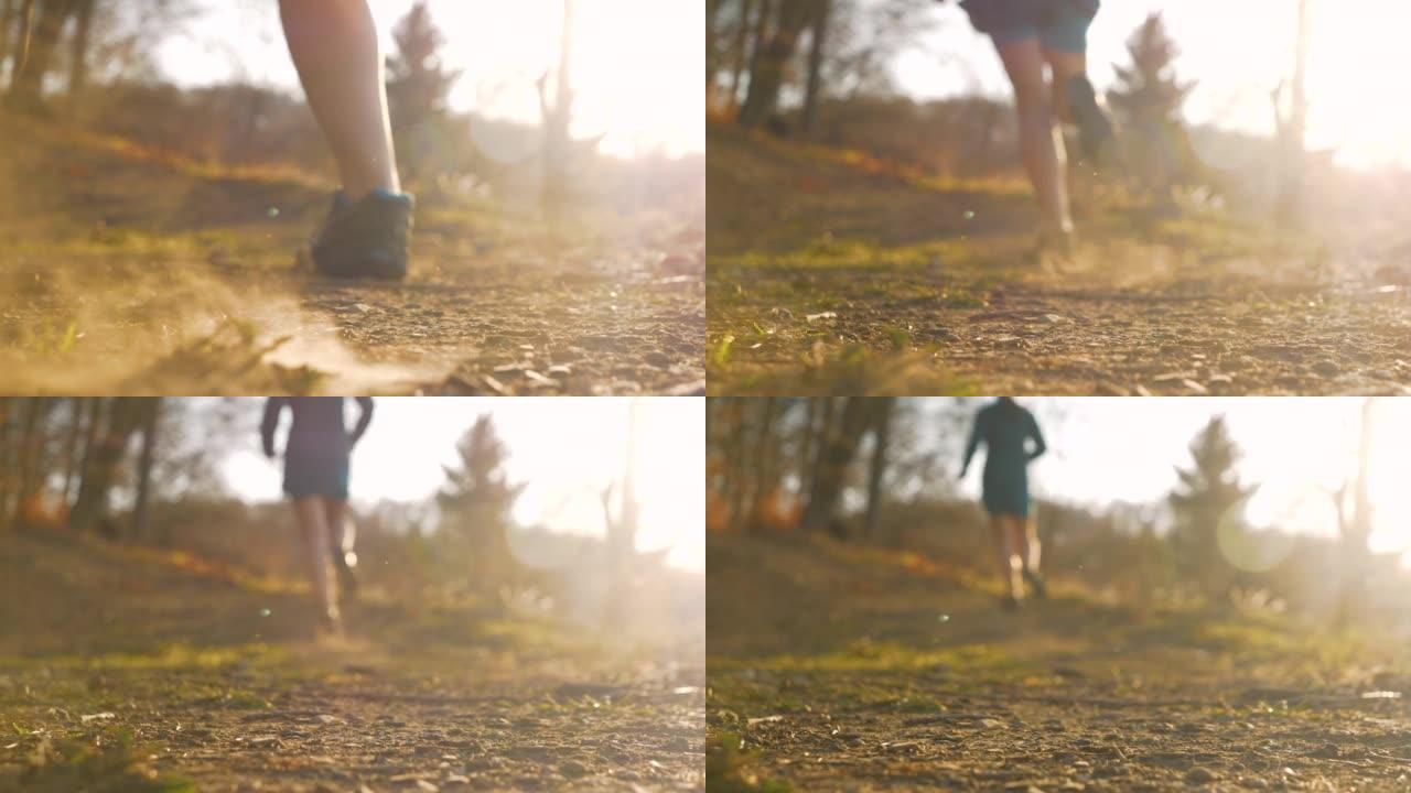 在干燥的砾石路径上，女性的腿从相机上跑开的慢动作视图