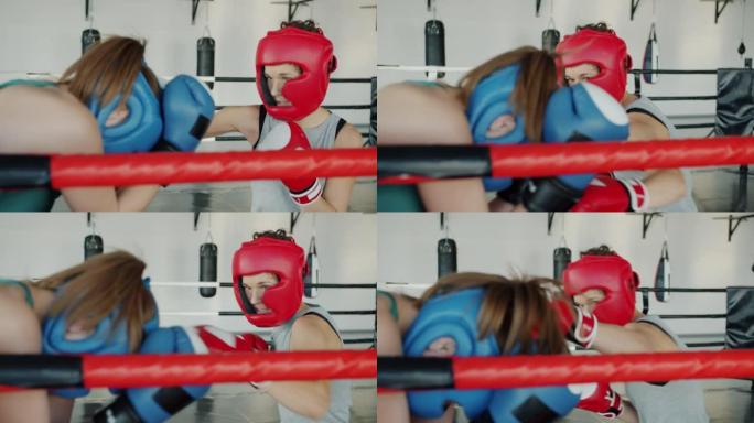在体育馆内与女对手进行激进的年轻战士拳击